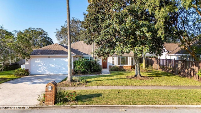 view of front of home featuring a front yard and a garage