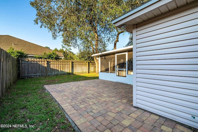 view of patio / terrace featuring a sunroom