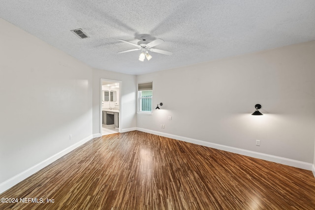 unfurnished room with a textured ceiling, wood-type flooring, and ceiling fan