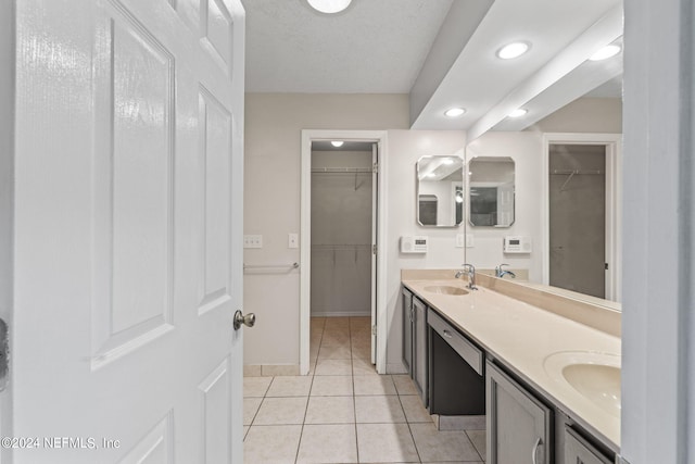 bathroom featuring vanity, a textured ceiling, and tile patterned floors