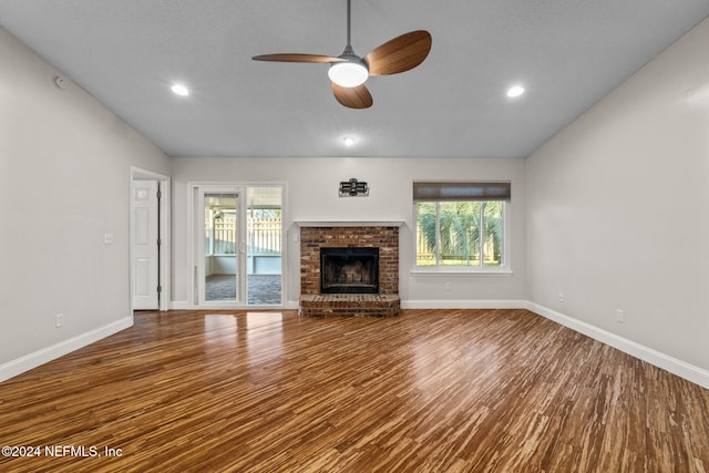 unfurnished living room featuring ceiling fan, wood-type flooring, vaulted ceiling, and a wealth of natural light