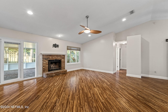 unfurnished living room with vaulted ceiling, a brick fireplace, wood-type flooring, and ceiling fan