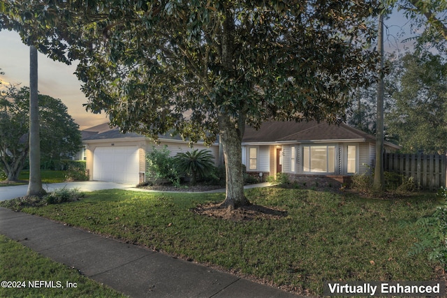 view of front of house with a yard and a garage