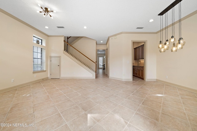 unfurnished living room with light tile patterned floors, a notable chandelier, ornamental molding, and a textured ceiling