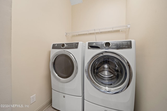 clothes washing area with washer and dryer