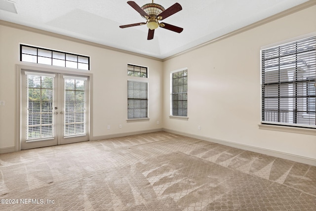 carpeted empty room with ceiling fan, a textured ceiling, crown molding, and french doors