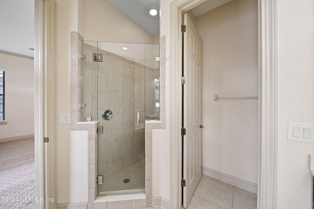 bathroom featuring a textured ceiling, tile patterned flooring, vaulted ceiling, and an enclosed shower