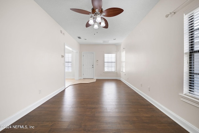 interior space with a textured ceiling, hardwood / wood-style floors, and ceiling fan