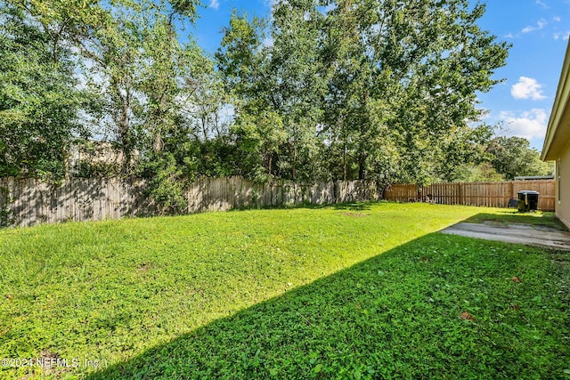 view of yard with a fenced backyard and a patio area