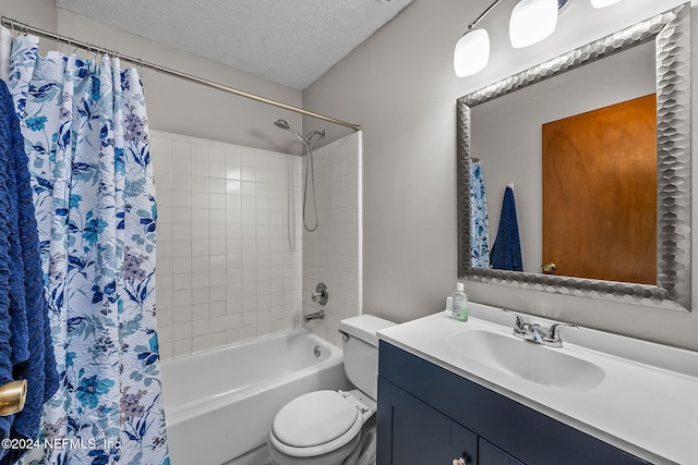 full bathroom with shower / bath combo with shower curtain, toilet, a textured ceiling, and vanity