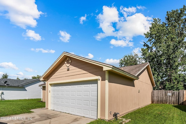 garage featuring wood walls and a yard