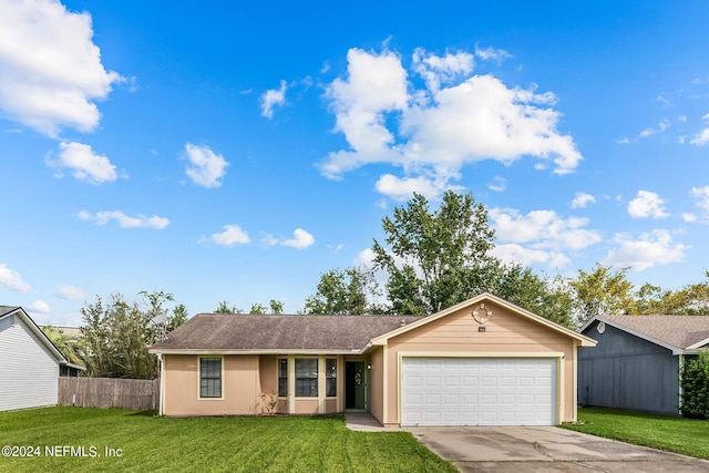 ranch-style house with fence, a front yard, driveway, and an attached garage