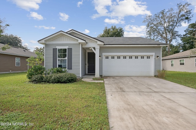 view of front of home with a garage and a front yard