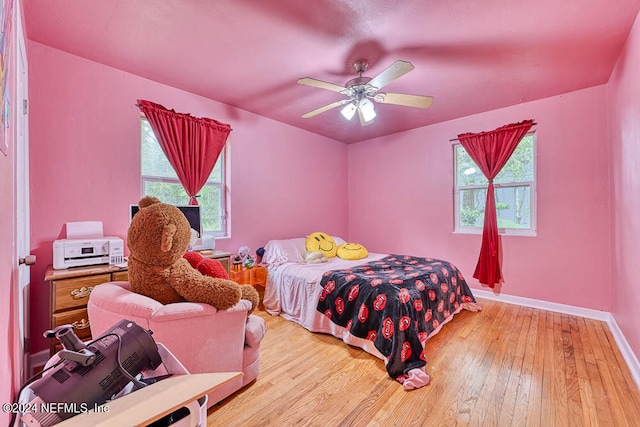 bedroom with wood-type flooring and ceiling fan