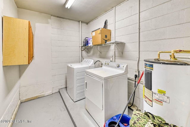 laundry room featuring electric water heater, cabinets, and washing machine and clothes dryer