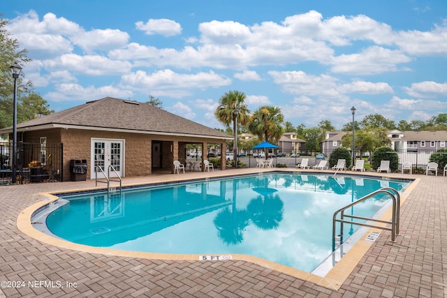 view of pool featuring a patio and french doors