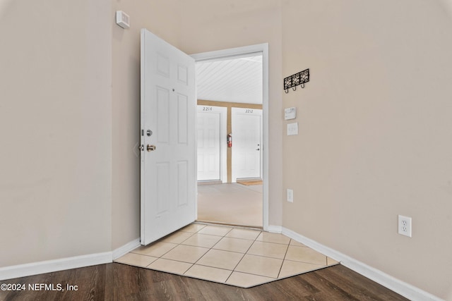 hallway with light hardwood / wood-style floors