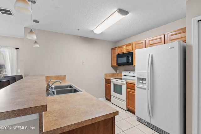 kitchen featuring white appliances, light tile patterned floors, pendant lighting, a textured ceiling, and sink