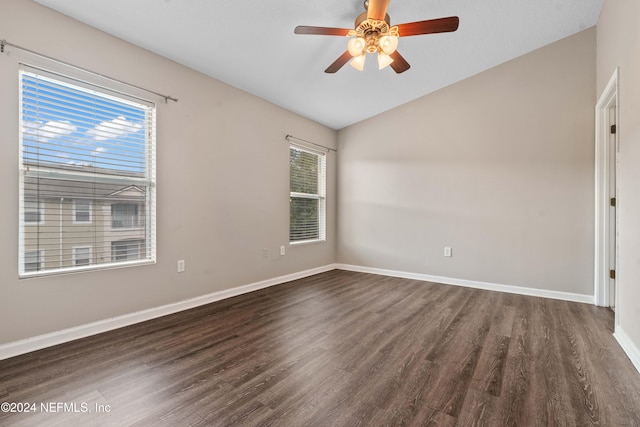 unfurnished room with ceiling fan, dark wood-type flooring, and a wealth of natural light