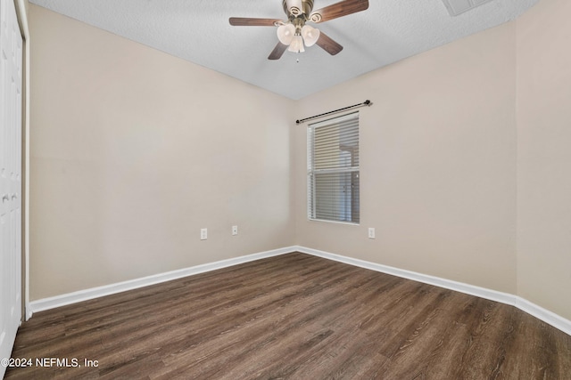 spare room featuring ceiling fan, a textured ceiling, and dark hardwood / wood-style flooring