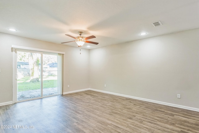 unfurnished room with ceiling fan and wood-type flooring