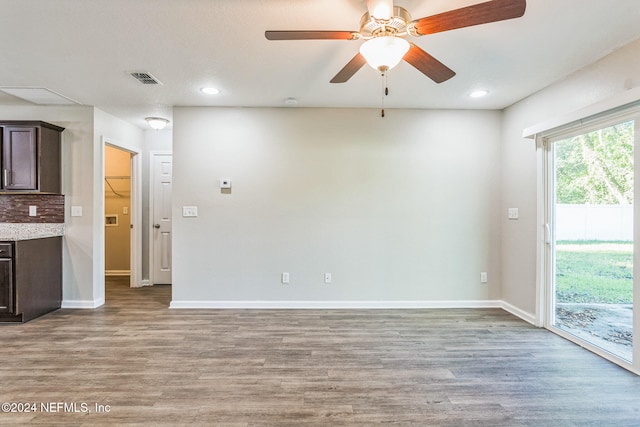 unfurnished living room featuring light wood-type flooring and ceiling fan