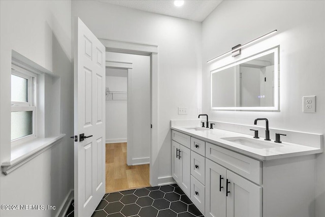 bathroom featuring tile patterned floors, a textured ceiling, and vanity