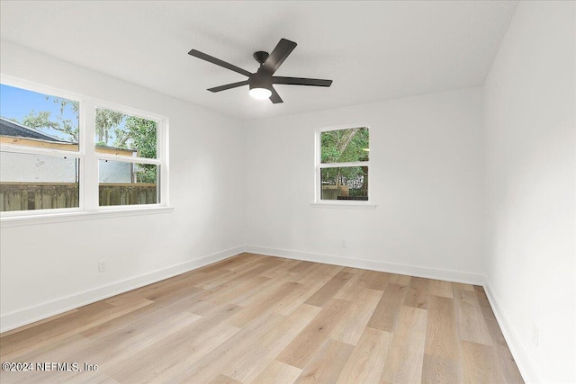 spare room with ceiling fan, light hardwood / wood-style flooring, and plenty of natural light