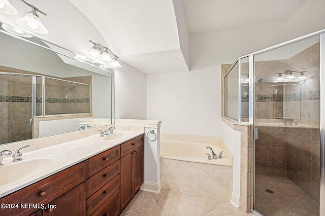 bathroom featuring vanity, vaulted ceiling, independent shower and bath, and tile patterned floors