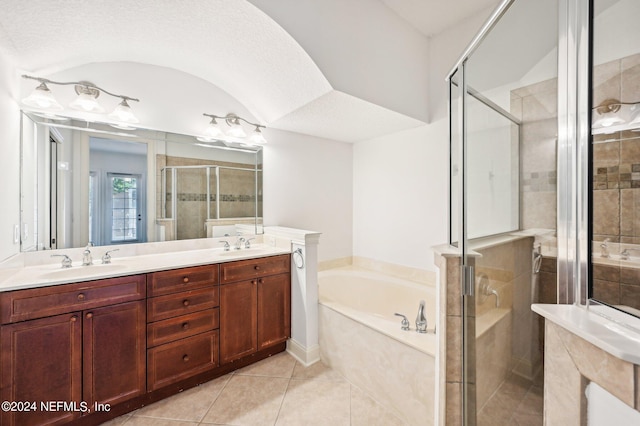 bathroom featuring vanity, a textured ceiling, separate shower and tub, and tile patterned flooring