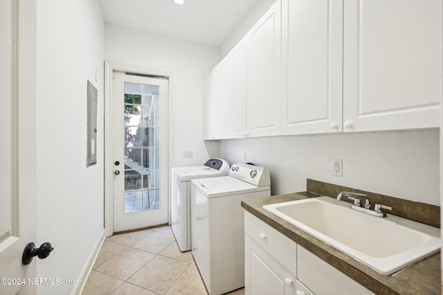 laundry area featuring sink, separate washer and dryer, light tile patterned floors, electric panel, and cabinets