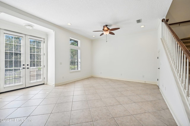 unfurnished room with french doors, ceiling fan, light tile patterned floors, and plenty of natural light