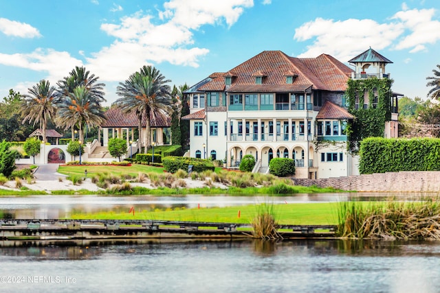 back of house featuring a water view and a balcony