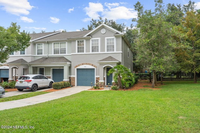 view of front of home with a garage and a front lawn