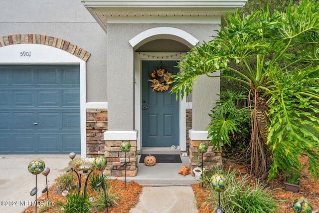 view of exterior entry featuring a garage