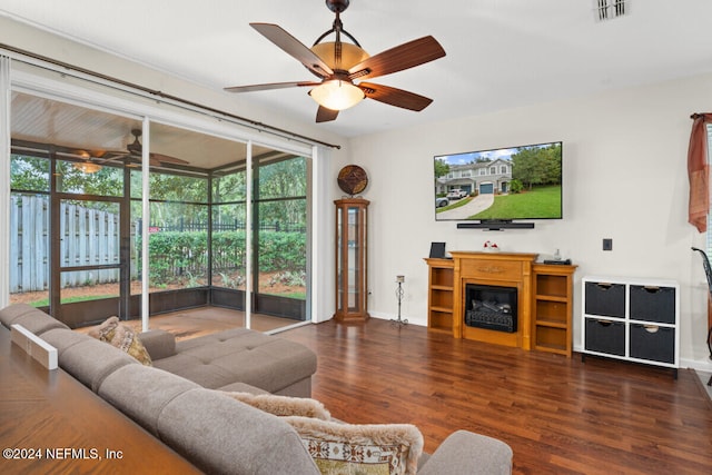 living room featuring ceiling fan, a wall of windows, and dark hardwood / wood-style flooring