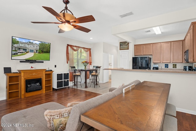 interior space featuring ceiling fan and dark wood-type flooring