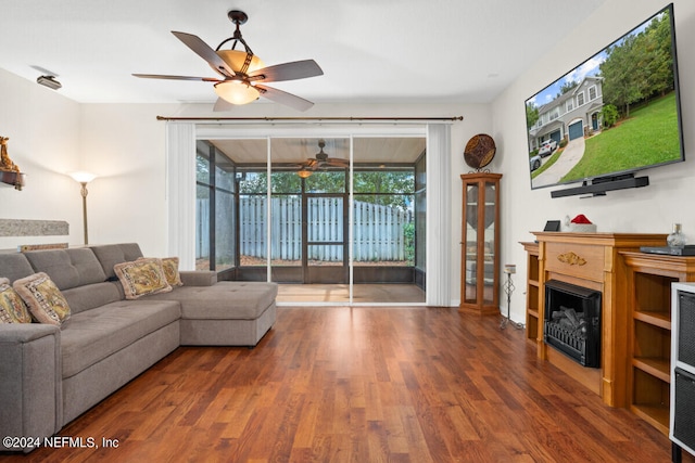 living room featuring wood-type flooring and ceiling fan