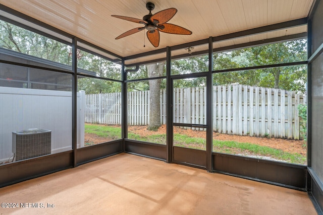 unfurnished sunroom featuring wooden ceiling, ceiling fan, and plenty of natural light