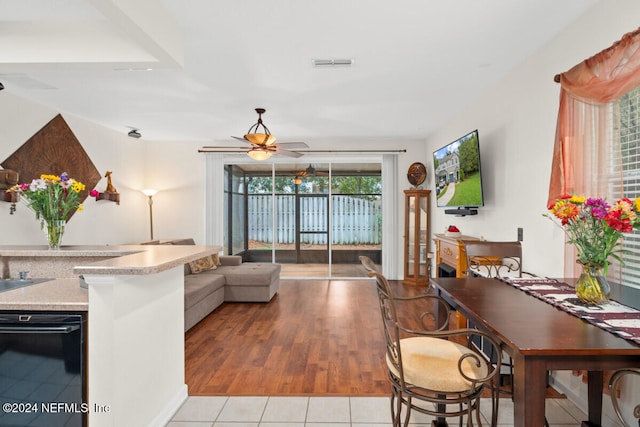 living room with ceiling fan and light hardwood / wood-style floors