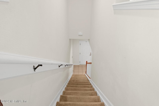 stairway with tile patterned flooring