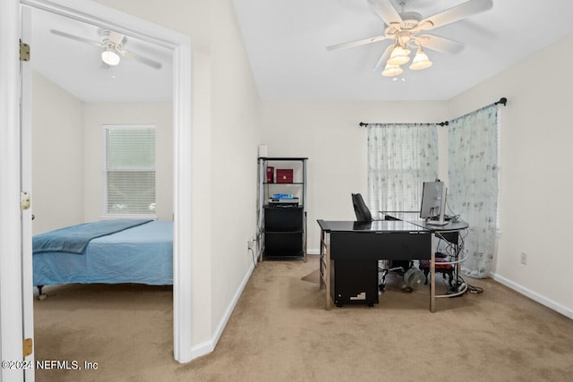 carpeted home office featuring ceiling fan