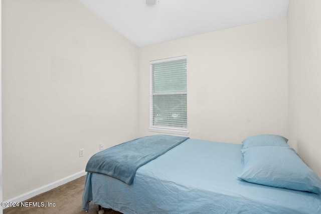 carpeted bedroom featuring lofted ceiling