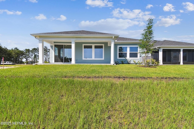 75582 Banyan Way, Yulee, FL 32097 - rear view of house with a sunroom and a lawn