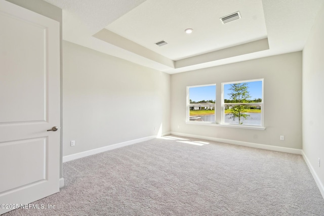 75582 Banyan Way, Yulee, FL 32097 - carpeted empty room featuring a tray ceiling and baseboards
