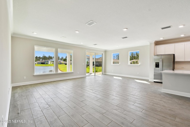 75582 Banyan Way, Yulee, FL 32097 - unfurnished living room featuring baseboards, light wood finished floors, recessed lighting, and crown molding
