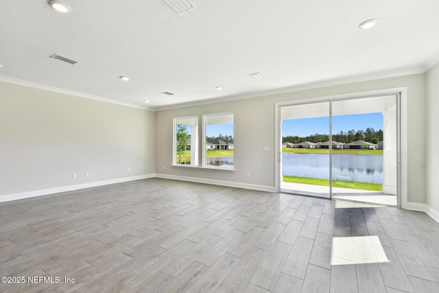 75582 Banyan Way, Yulee, FL 32097 - unfurnished room featuring ornamental molding, wood finished floors, baseboards, a water view, and a textured ceiling