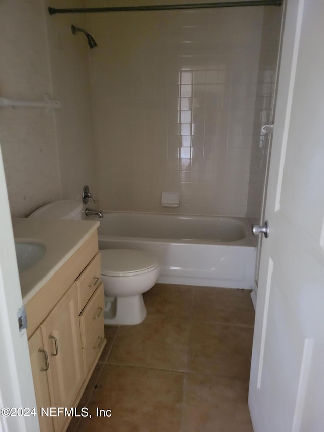 full bathroom with vanity, tiled shower / bath combo, toilet, and tile patterned floors