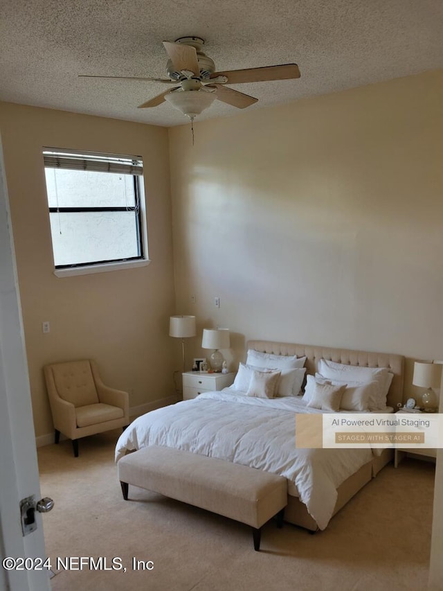 bedroom featuring a textured ceiling, carpet flooring, and ceiling fan