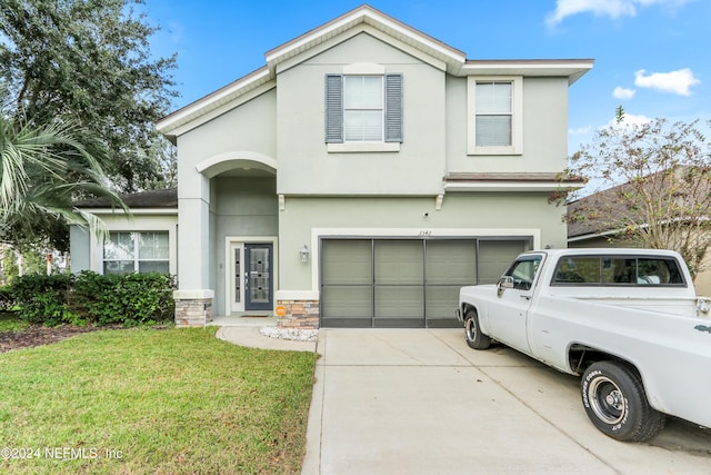 front facade featuring a front yard and a garage